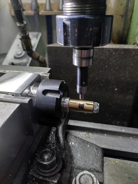 A collet block is held in the vice of a metal mill. In the collet block
is a aluminium arbor. Attached to which is a section of brass, which is
then held with a steel nyloc nut.
